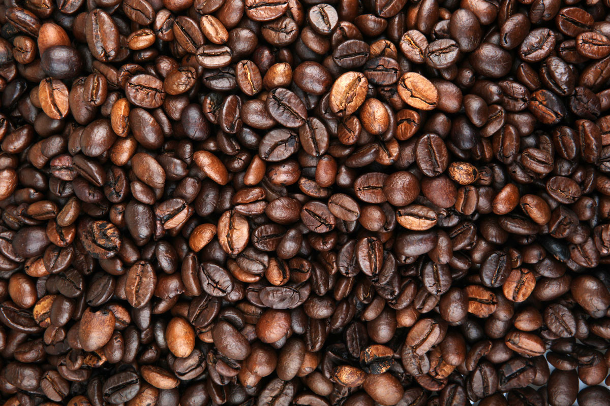 A pile of coffee beans covers the image edge to edge.